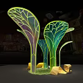 Colorful Leaf Shaped Glowing Light Installation With Yellow Stones And Grass