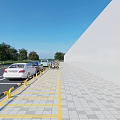 Modern Road Facilities With Parking Spaces Yellow Lines Guardrails Parked Cars And Paved Sidewalk