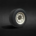 Black Vehicle Tire With Silver Metal Rim And Detailed Tread Pattern On Dark Background