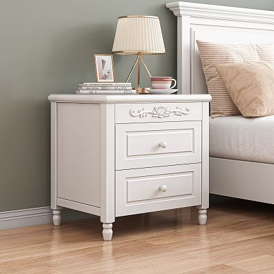 White Bedside Table With Two Drawers Decorative Carvings Table Lamp Books Photo Frame And Mug 3d model