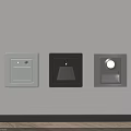 Three Different Colored Square Wall Lights Installed On Light Colored Wall With Wooden Floor