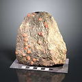 Natural Wood Stone With Red Spots On Black And White Checkered Base