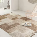 Square Rug with Beige Brown Patchwork and Tassels in White Room with Transparent Chair