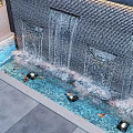 Serene Garden Water Feature With Flowing Wall And Fish In Blue Pool
