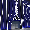Blue Wavy Storefront Design With White Lighting Lines And SPACE Sign Entrance