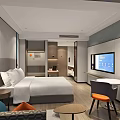 Modern Hotel Room Interior With Comfortable Bed White Bedding Sofa Colored Cushions TV And Desk