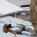 Serene Garden Landscape With Natural Stone Fountain Flowing Water And Paved Surroundings