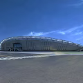 Modern Football Stadium With Curved Roof Green Pitch And Colorful Seats Under Blue Sky