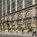 Modern Multi Story Office Building Exterior With Large Glass Windows Illuminated Facade And Surrounding Trees