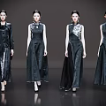 Women in elegant black cheongsam walking on fashion runway with exquisite patterns