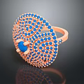 Elegant Orange Metal Ring With Blue Gemstone Center And Decorative Blue Stones