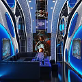 Modern KTV Interior Design Featuring Blue Lighting Comfortable Sofa TV Screens And Futuristic Decor