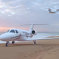 Large Modern Passenger Plane Parked On Sandy Beach During Sunset With Other Aircraft Nearby