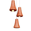 Three Orange Polygonal Cone Pendant Lights Illuminated in Modern Interior Space