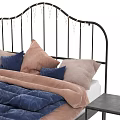 Modern Double Bed with Metal Frame Blue Comforter Pink and Blue Pillows and Sleek Nightstands