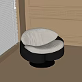 Modern Curved Lounge Chair With White Upholstered Cushion And Black Circular Base
