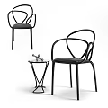 Modern Black Leisure Chair With Curved Metal Frame And Side Table Decor