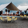 Outdoor Table on Beach with Yellow Chairs White Tents Palm Trees and Lights