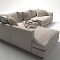 Light Beige Sectional Sofa With Plush Pillows And Cozy Throw Blanket In Modern Living Room
