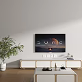 Modern White TV Stand With Flat Screen TV Green Plant And Wooden Floor