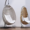 Modern Woven Hanging Chairs With White Cushions And Metal Stands For Indoor Use