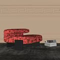 Red Fuzzy Ottoman With Black Legs On Gray Rug And Stacked Magazines