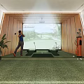 Modern Entertainment Room With Golf Practice Large Screen Course Display Clubs Mats And Green Carpet