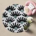 Round Rug with Black and White Floral Pattern Teal Accents Pink Armchair in Cozy Corner