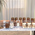 Assorted Food Jars With Nuts And Marshmallows On Table Curtain Background And Potted Plant