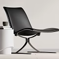 Modern Black Leather Accent Chair With Metal Frame And White Cylindrical Side Table