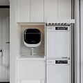 Home Balcony Laundry Space With White Cabinets Countertop Faucet And Stacked Appliances