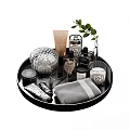 Elegant Bathroom Accessories On Black Tray With Silver Container Brush Candle Towel And Green Leaves