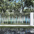 Modern Building Exterior Wall Design With White Columns Metal Railings Green Trees And Lush Grass