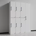White Modern Locker Cabinet With Multiple Doors Black Handles And Locks Against Gray Wall