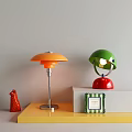 Orange Mushroom and Green Helmet Style Table Lamps with Silver Red Bases on Colorful Stands