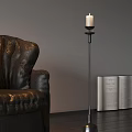 Elegant Candle Lamp Beside Black Leather Sofa and Open Book in Interior