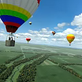 Colorful Hot Air Balloons As Amusement Equipment Flying Over Green Fields With Trees And Roads