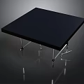 Square Black Table With Metal Legs On Dark Background With Reflection