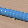 Construction Site Blue Corrugated Pipe with Support Blocks on Ground and Trees Background