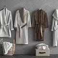 Different Colored Bath Robes Hanging On Gray Wall With Wicker Basket And Storage Box