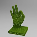 Green Granular OK Hand Gesture Sculpture Composed of Small Particles With Square Base