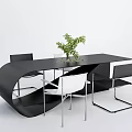 Modern Black Curved Table with White and Black Chairs and Green Plant Centerpiece