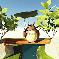 Cute Totoro Sitting On Wooden Branch Surrounded By Green Leaves Under Blue Sky