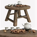 Round Wooden Coffee Table With Crossed Legs Design Featuring Tea Set Nuts And Tea Cups