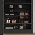 Various Stylish Bags And Boxes Displayed On Black Shelves With Folded Fabrics