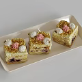 Layered Square Pastries with Cream Toppings Gold Sprinkles and Pink Accents on a Tray