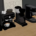 Three Metallic Coffee Machines On Wooden Table With Coffee Cups And Mug