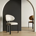 Cream And Tan Dining Chairs With Black Metal Legs Against Dual Tone Walls And Wood Flooring