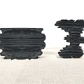 Black Rockery Stones With Layered Texture As Decorative Ornaments On Linen Surface