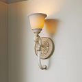 Classic White Frosted Shade Wall Sconce With Ornate Carved Base And Warm Yellow Light